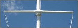 A yardarm connected to a traditional flagpole